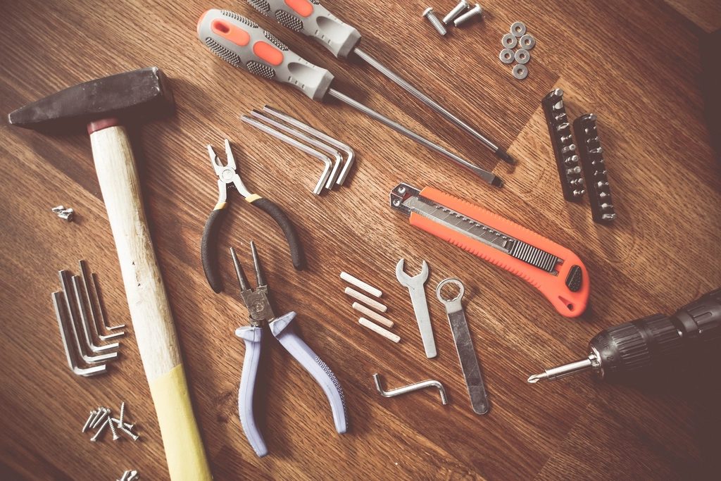 Hand tools laid out on a wooden bench